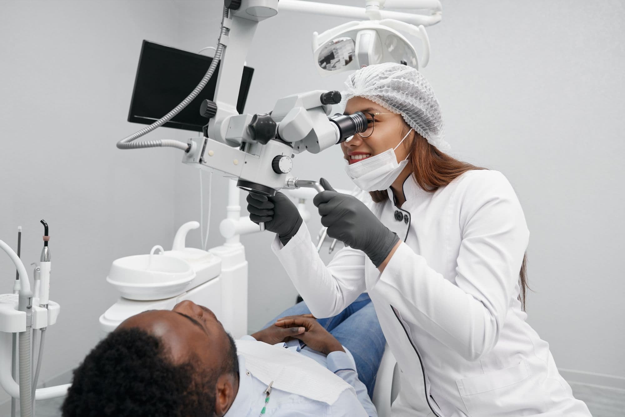 A dentist using a dental microscope