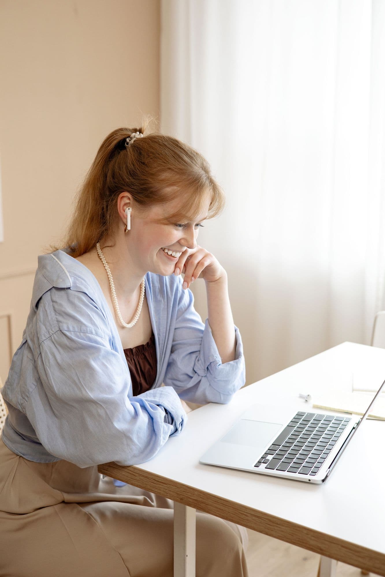 A woman comparing information on a laptop